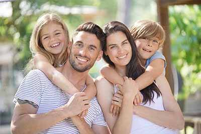man and woman with their two children